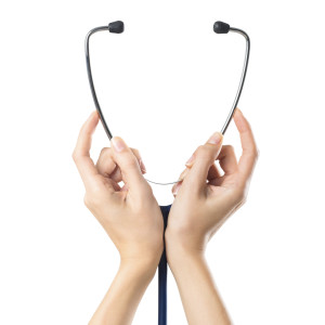 Closeup shot of a woman hand holding a medical stethoscope isolated on white background. Close up of stethoscope holding with two female hands.